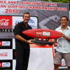 Bruce Waterfield of CCIA receives surfboard from ISC’s Tipi Jabrik